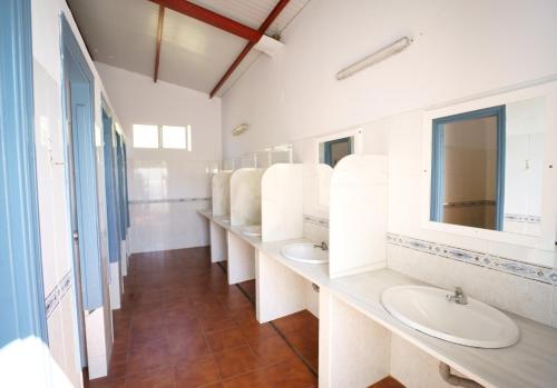 塔里法Kampaoh Valdevaqueros的浴室设有3个水槽和一排镜子