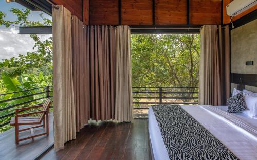 锡吉里亚Atha Resort的一间卧室设有一张床和一个大窗户