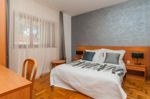 大洛希尼Apartments by the sea Mali Losinj (Losinj) - 3444的一间卧室设有一张大床和一个窗户。