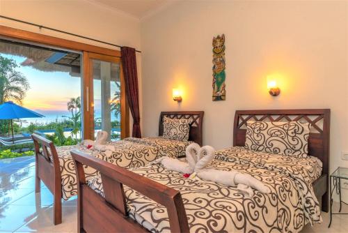 乌明亚北角海滩别墅的一间带两张床的卧室,享有海景