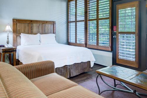加特林堡伊克斯波罗尼亚加特林堡镇广场度假酒店的一间卧室配有一张床、一张沙发和一张桌子