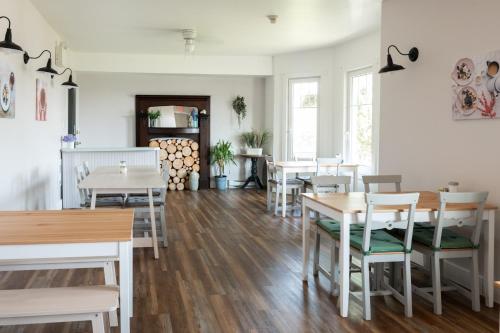 St. Peter'sPepperell Place Inn Inc.的一间设有白色桌椅的用餐室