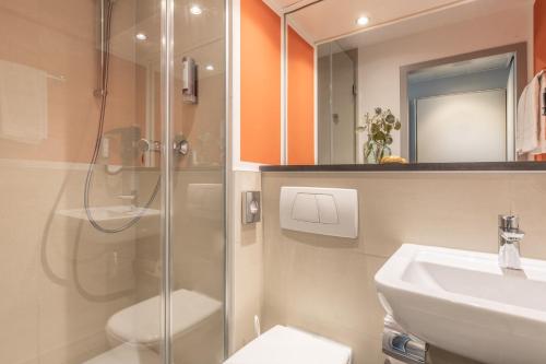 威斯巴登Select Hotel Wiesbaden City的带淋浴、卫生间和盥洗盆的浴室