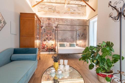 巴勒莫Vossia Luxury Rooms & Sicilian Living的客厅配有蓝色的沙发和床。