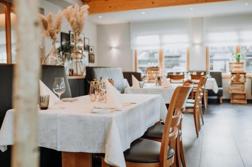 平德里希Hotel Restaurant zur Marienburg的一间设有白色桌椅的用餐室