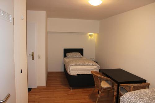 科隆加尼埃米尔酒店的小房间设有两张床和一张桌子