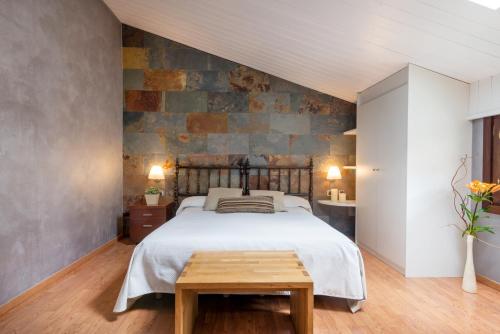 里贝斯的弗里瑟埃尔斯卡卡都德瑞贝斯酒店的一间卧室设有一张床和石墙
