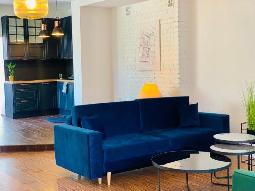 瓦尔米亚地区利兹巴克Apartamenty Krasicki的客厅配有蓝色的沙发和桌子