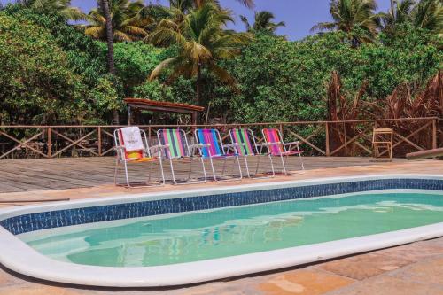 阿廷斯Prana Eco Villa的一组椅子坐在游泳池旁
