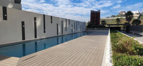 康康Tranquilo departamento Dunas de Concon的大楼旁的游泳池