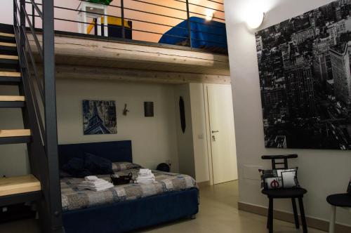 阿夸拉尼亚B&B Aquilegia的一间卧室设有双层床和楼梯。