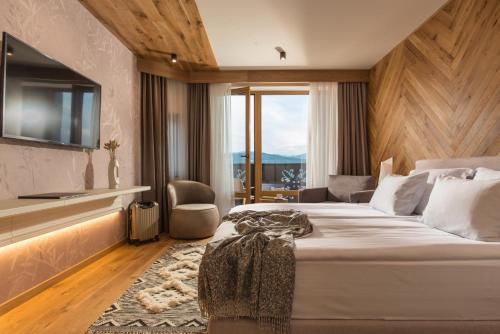 特里亚夫纳Wine & SPA Hotel Chukara的一间设有大床和窗户的酒店客房