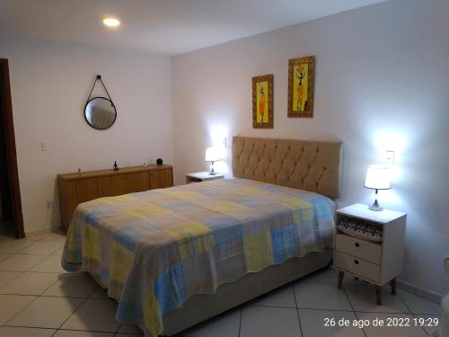 里约热内卢Cantinho Bonsai的一间卧室配有一张床、两个床头柜和两盏灯。