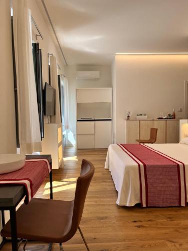 马达莱纳Dimora Elle的酒店客房,配有两张床、一张桌子和一把椅子