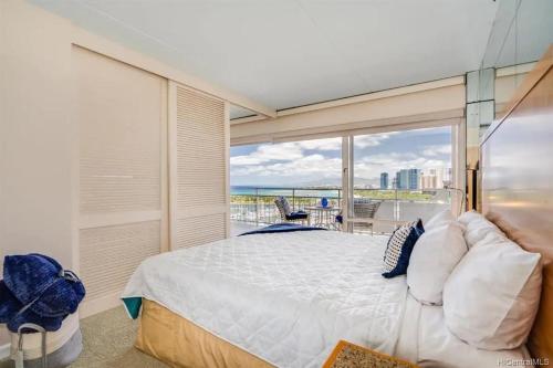 檀香山Ilikai #1743 Panoramic views on Waikiki Beach的一间带大床的卧室和一个阳台