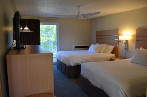 托伯莫里Bruce Anchor Motel and Cruises的酒店客房设有两张床和一台平面电视。