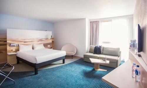 土伦土伦中心港宜必思尚品酒店的酒店客房,配有床和沙发
