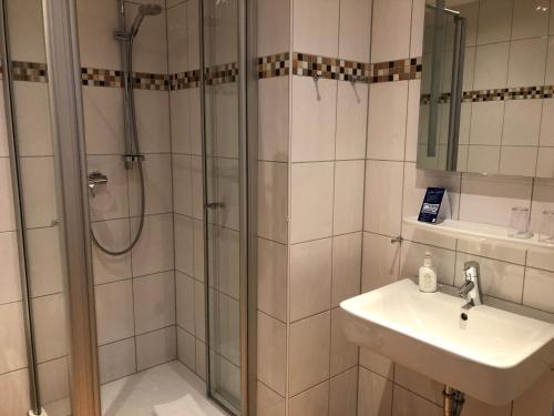 维利希胡贝托斯汉玛赫酒店的带淋浴和盥洗盆的浴室