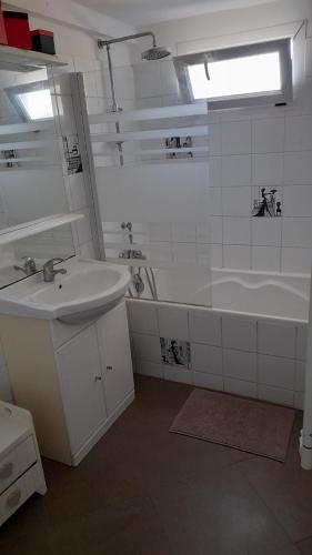圣弗洛朗Casa Francesca的白色的浴室设有水槽、浴缸和水槽。