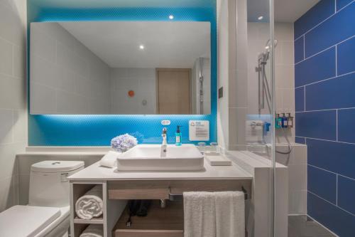 上海上海嘉定城中智选假日酒店的一间带水槽、镜子和卫生间的浴室
