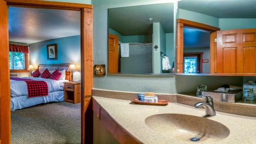 阿什兰Callahan's Lodge的一间带水槽的浴室和一间带一张床的卧室