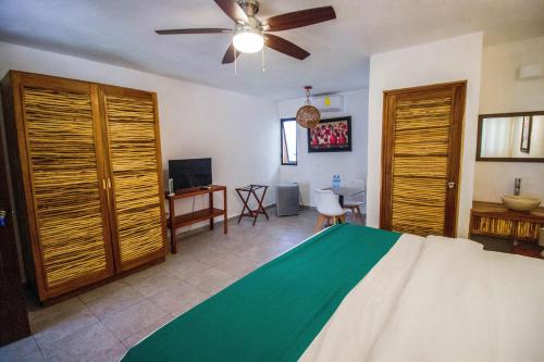 坎昆Hotel Tequila Cancun的一间卧室配有一张床和吊扇