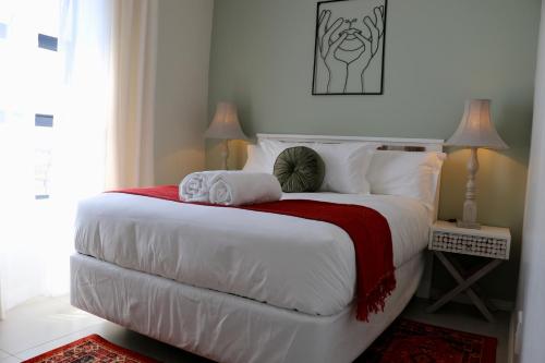 米德兰The Red Portrait at Carlswald的卧室配有一张带红色毯子的白色床