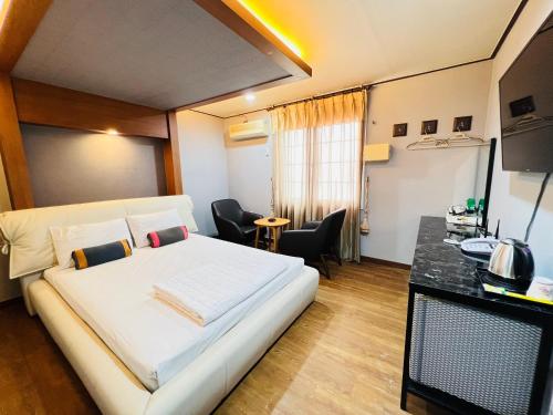 济州市Sweet Hotel的卧室配有一张白色的大床和一张桌子