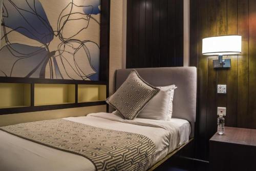 新加坡3号航站楼大使过境休息室酒店的一间卧室配有一张壁画床