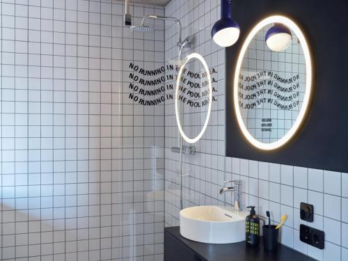 美因河畔法兰克福STAYERY Frankfurt Sachsenhausen的浴室设有两面镜子和盥洗盆