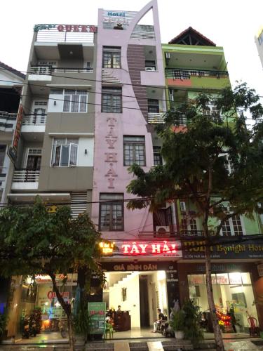 岘港OYO 1171 Tay Hai Hotel的前面有出租车标志的高楼
