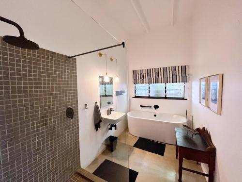巴利托B'Lenghi Beach House的带浴缸、水槽和浴缸的浴室