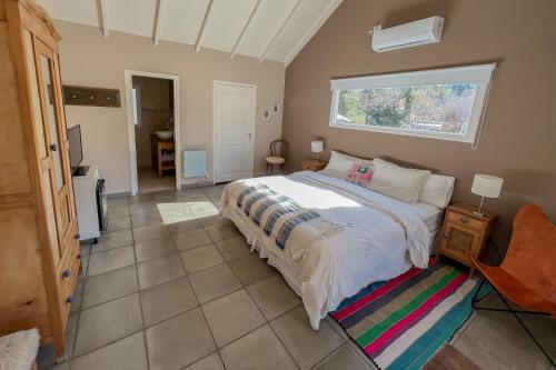 吉亚迪诺镇Chacra La Invernada Pequeño Hotel de Campo的一间卧室设有一张大床和一个窗户。