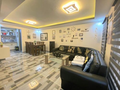 MalabañasMAJESTIC 2 BR TOWNHOUSE - near AQUA PLANET & CLark Airport - TRP8的客厅配有真皮沙发和桌子