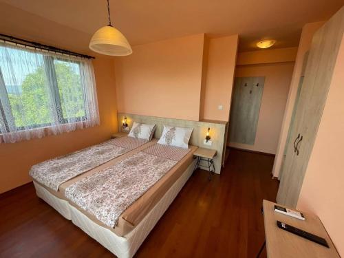 GostilitsaКомплекс Белла Терра的一间卧室设有一张大床和一个窗户。