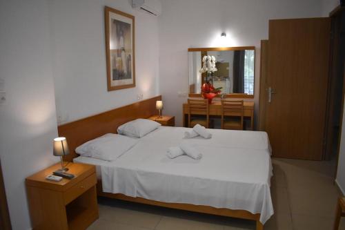 卡梅纳维洛拉Hotel Ritsa的一间带白色床的卧室和一间用餐室