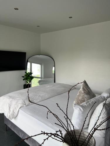 汉诺威Luxus Villa Hannover Messe的白色卧室配有一张带镜子的大床