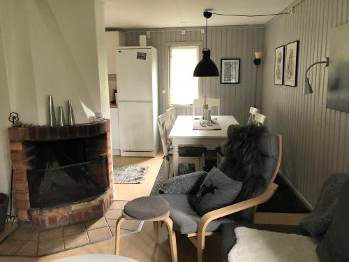 Fjällgården Grövelsjön Lillstugan的客厅配有椅子和壁炉