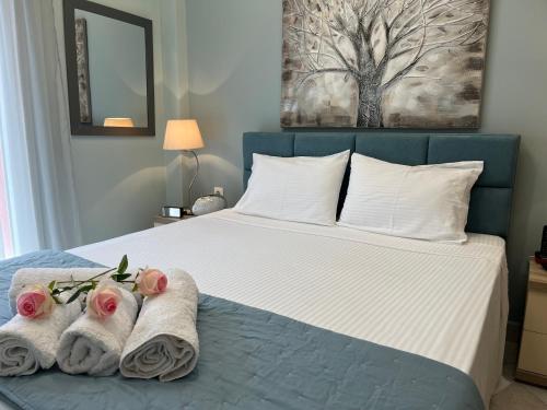 卡瓦拉Kavala Port Apartments的一间卧室配有带毛巾的床