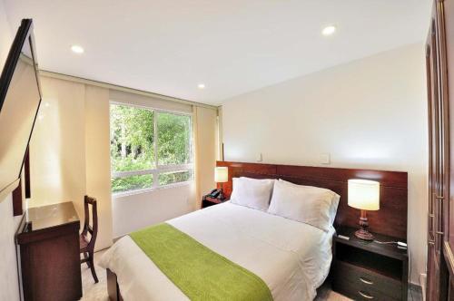 布卡拉曼加帕隆格酒店的一间卧室设有一张大床和一个窗户。