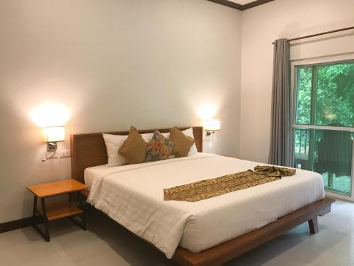 瑶亚岛Koh Yao Yai Sea Breeze House เกาะยาวใหญ่ซีบรีซเฮ้าส์的一间卧室设有一张大床和一个窗户。