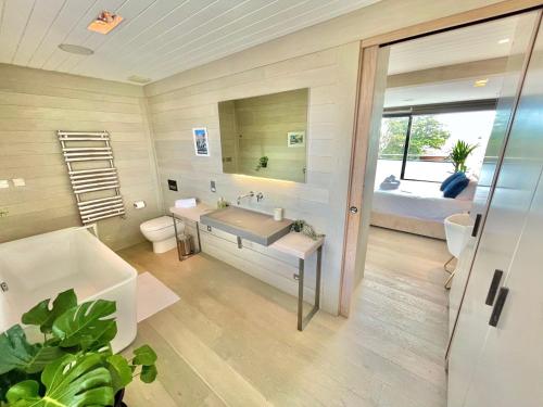 伯恩茅斯The Beach Hytte - Stunning Sea View Penthouse的带浴缸、水槽和床的浴室