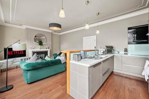 韦克菲尔德Stunning Georgian Apartment In Yorkshire - Parking的厨房以及带绿色沙发的起居室。