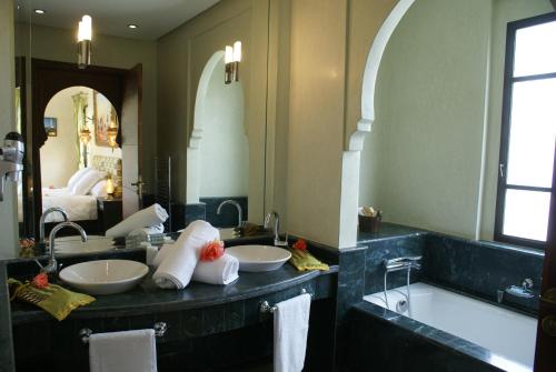 NajemLa Kasbah Aalma D'or的一间带两个盥洗盆和大镜子的浴室