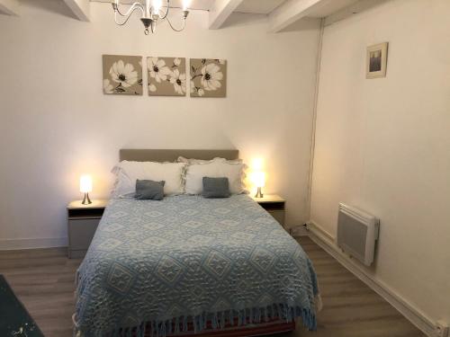 Oradour-FanaisGîte des Lavandes的一间卧室配有床,两台桌子上有两个灯