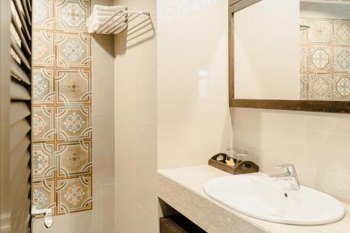 库塔峇里岛棕榈滩大酒店的一间带水槽和镜子的浴室