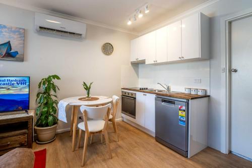 奥兰治One-Bedroom Apartment on Summer的厨房以及带桌子和水槽的用餐室