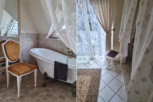 穆扎希赫尔Villa Toscana Boutique的一间带浴缸和靠窗的椅子的浴室