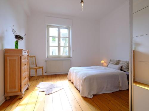 埃森Entspanntes Wohnen in der Nähe des Baldeneysee的一间卧室配有一张床、梳妆台和镜子