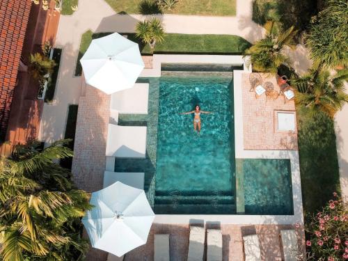 乌鲁瓦图Terra Cottages Bali的男人在游泳池游泳的顶部景色